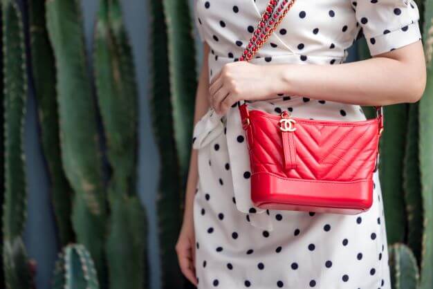 women with red chanel bag