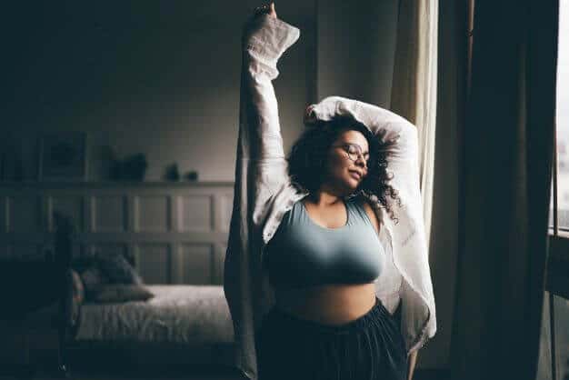 Curly haired plus size woman wearing comfortable clothes