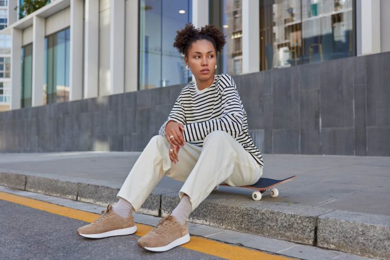 streetwear style of woman on skateboard