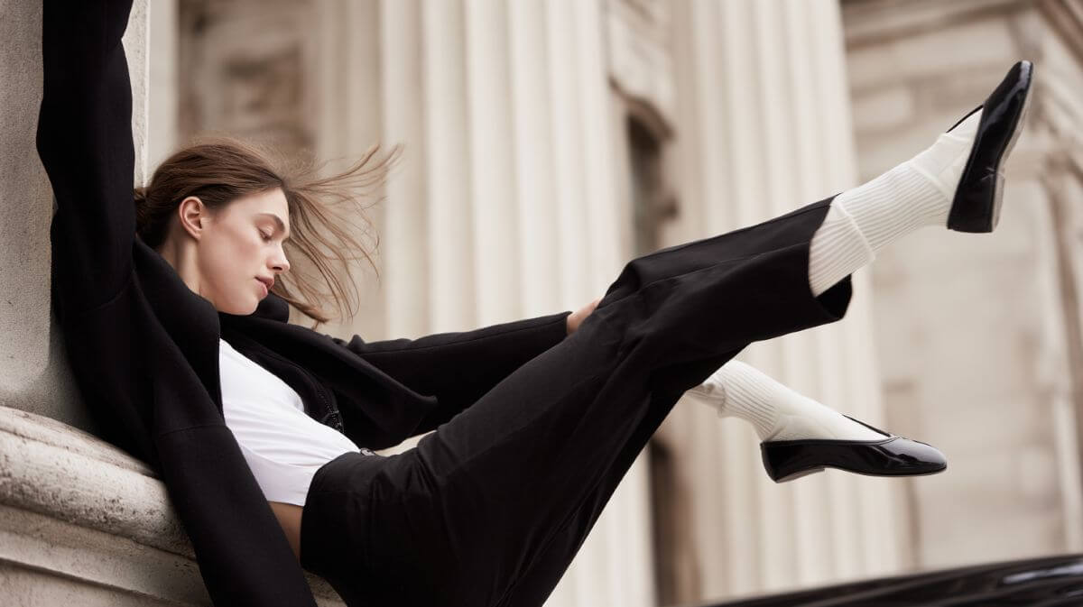 Close-up of ballet flats paired with white socks, showing a trending fashion combo for 2025