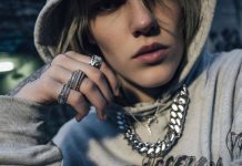 Streetwear model wearing chunky rings and chain necklace with hoodie