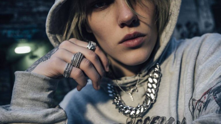 Streetwear model wearing chunky rings and chain necklace with hoodie